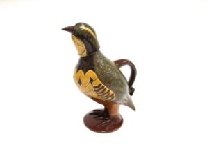 A Phil Arthur pottery slip ware terracotta jug and cup modelled as a partridge. Impressed seal