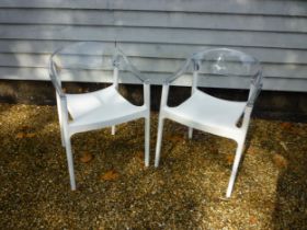 A pair of white and clear plastic 'Carmen' chairs by Siesta