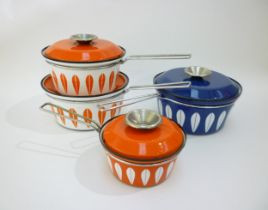 Four Catherine Holm of Norway saucepans of various sizes in blue and white and red and white.