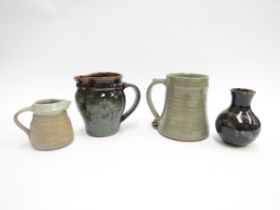 A collection of Leach and similar pottery including a tankard with scrolled handle, a Leach