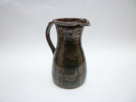 A tall Winchcombe studio pottery stoneware jug. Tenmoku glaze and finger wipe detail. Seal under