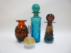 A Mdina bottle vase and stopper in amethyst and blue with overlay strapping. Plus a red vase with