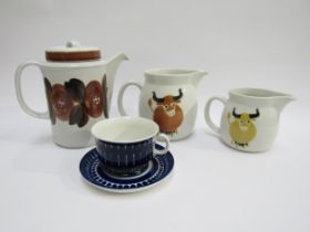 Two Arabia Kaj Franck designed cow image jugs, a yellow one, 10.5cm high and a light brown one 13.