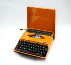 A Smith Corona GT Typewriter in orange, 'Design by Ghia'
