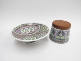 A Swedish Laholm Pottery small pedestal dish with painted decoration and a canister with wooden lid.