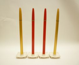 Four Ronsons 'Varaflame' candles with bases. 40cm high