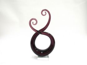 A Murano style amethyst glass swirl sculpture on a clear glass plinth base. 33.5cm high
