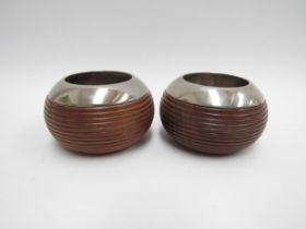 A pair of "Linley" candle holders in reeded walnut with chromed metal collars, stamped Linley to