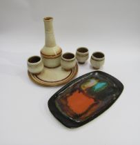 A Celtic Pottery of Cornwall decanter 25.5cm high, tray and four beakers in the 'Medallion' design