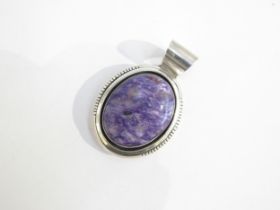 A J. Peters Sterling pendant of oval form, inset with a panel of purple agate stone. Pendant 5.
