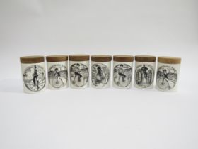 A group of seven Portmeirion Pottery canisters, "Velocipedes" range with wooden lids. 10cm high