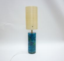 A Shatterline blue lamp base with an off white spun fibre shade. 50cm high including shade