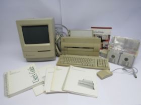 An Apple Macintosh Classic personal computer with Stylewriter printer, keyboard, mouse, floppy dics,