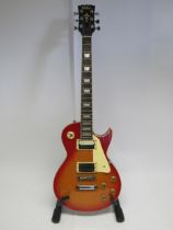 A Vintage Les Paul copy electric guitar in sunburst finish, with stand and soft case