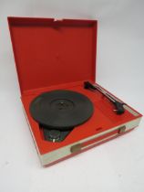 A vintage Fidelity HF42 portable record player in red plastic casing