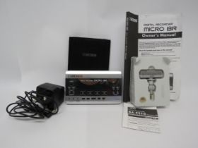 A Boss Micro BR digital recorder with BA-CS10 stereo microphone, power supply and instructions