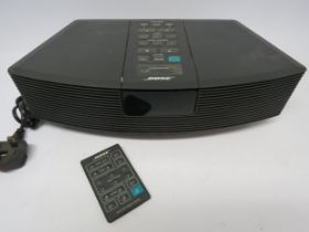 A Bose Wave AWR1-RW clock radio with remote