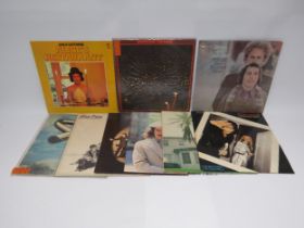 A collection of nine assorted LPs to include Bob Dylan, Arlo Guthrie, Mike Oldfield, Wings,