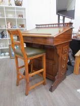 A circa 1900 shipping clerk’s desk, spindle gallery back, green tooled leather sloped surface with