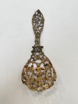 A William Comyns silver gilt pierced highly decorative caddy spoon, 28g, 12.5cm long
