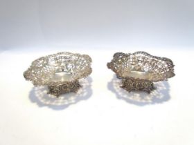 A William Comyns & Sons silver pair of footed bonbon dishes, ribbon, swag and foliate pierced