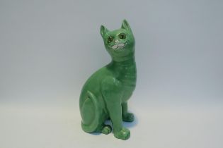 A Galle style Staffordshire cat, green glazed with glass eyes, standing 33.5cm tall