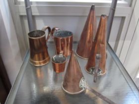 A Georgian copper tankard with wooden base, three copper funnel grain measures and two further
