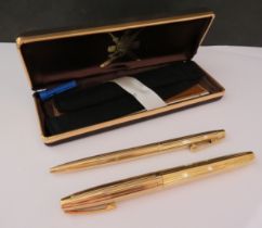 A pair of Schaeffer pens, 18ct gold nibs, Oman Arabic text, emblem to inner lid of case