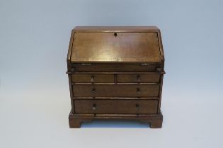 A 19th Century apprentice piece oak two small drawer over long drawers bureau fitted compartment,
