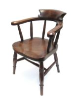 A late Victorian elm child's Captains armchair the broad arms over ring turned supports and legs