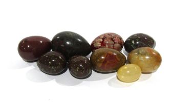 Seven polished stone eggs and another, all of varying sizes, largest 7cm, smallest 4cm
