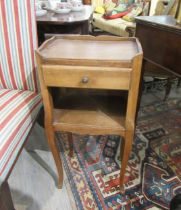 WITHDRAAWN: A 20th Century French oak bedside table with drawer and recess, raised on cabriole