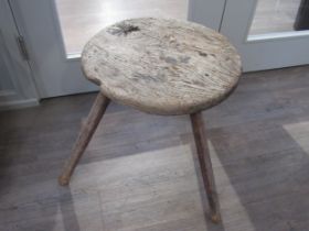 A primitive 18th Century Elm cricket table with thick circular top on three rustic legs. 53cm tall x