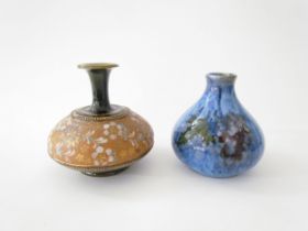 A Cobridge Stoneware onion shaped vase in mottled blue glaze with bunches of grapes and vine leaf