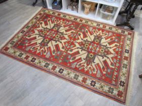 A Middle Eastern geometric floral pattern rug, terracotta ground, 206cm x 126cm