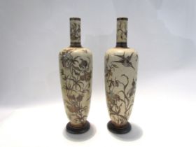 A pair of Martin Brothers stoneware vases of tall slender form, incised with birds and insects in