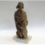 A 17th Century European carved lime wood figure of a saint in a time worn state mounted on a
