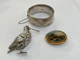 A silver brooch in the form of a snipe 6.5cm tall, silver bangle and brooch with landscape scene,