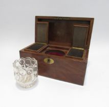 A mahogany tea caddy with two hinged lidded tea cannisters and glass mixing bowl