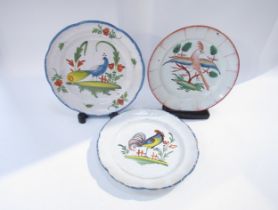 Seven late 18th/19th Century French Faience plates with bird decoration. Two with staple repairs,