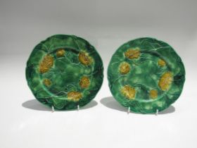Two J. Adams & Co. majolica cabbage leaf plates in yellow and green, each 22.5cm diameter