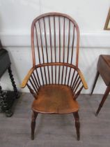 A pair of circa 1800 his and hers Windsor chairs, the hoop and stick-back over a solid elm seat,