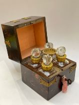 A 19th Century French scent bottle set, the case with figured hardwood veneer, with applied gilt