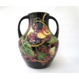A Moorcroft Queen's Choice pattern large twin handled vase, by Emma Bossons. Second, 34cm tall