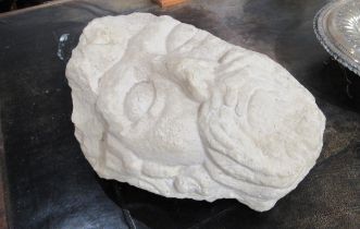 A carved limestone sculpture in the form of a head, 28cm x 20cm x 18cm