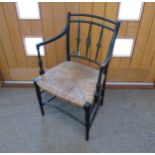 A Regency ebonised carver chair with rush seat, 87cm x 54cm x 43cm