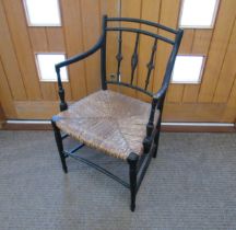 A Regency ebonised carver chair with rush seat, 87cm x 54cm x 43cm