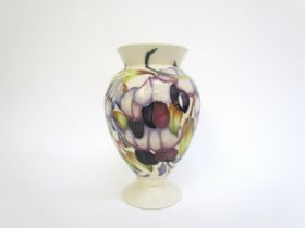 A Moorcroft vase designed by Emma Bossons, Purple Wisteria, 18cm tall