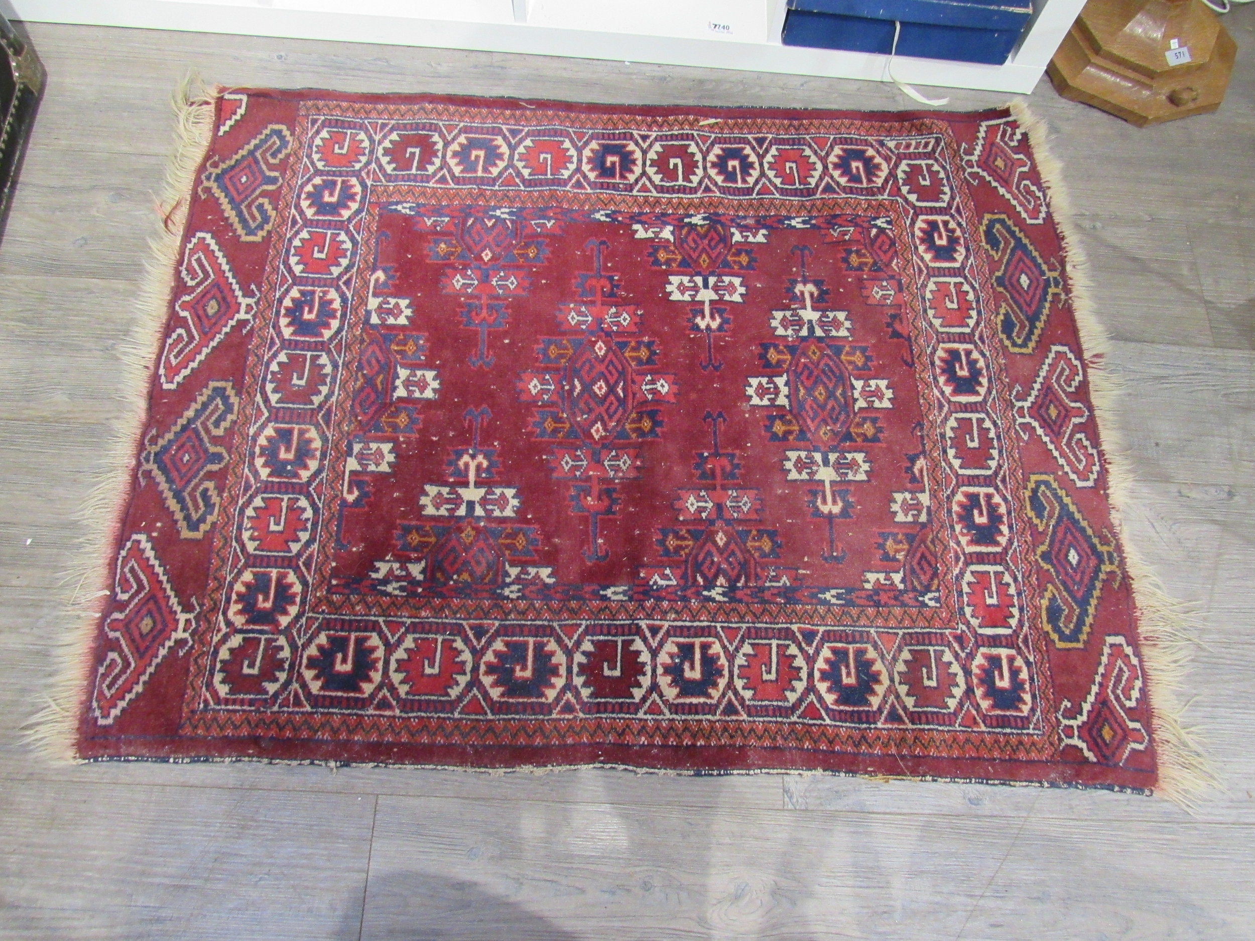 An Afghan rug, burgundy ground with geometric patterns, 115cm x 92cm