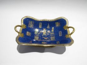 A Carlton Ware boat shaped twin handled bowl depicting Egyptian scenes, gilt embellishment, 30cm